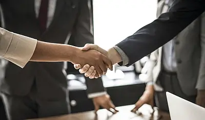 Two business people standing shaking hands