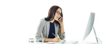 Business woman on phone and looking at computer screen