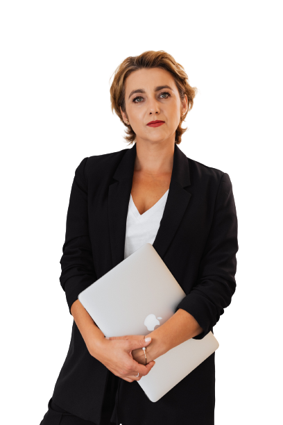 Photo of a  woman standing with her arms folded holding a closed laptop