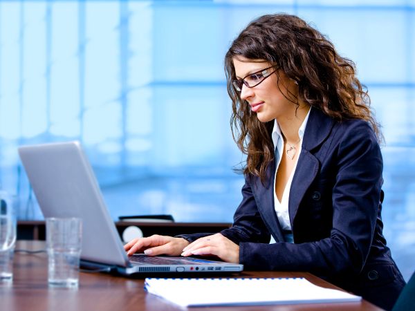 Woman sitting at desk using laptop