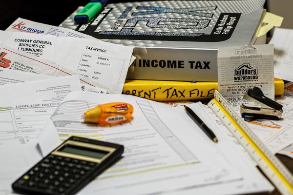 calculator, tax records and book about income tax